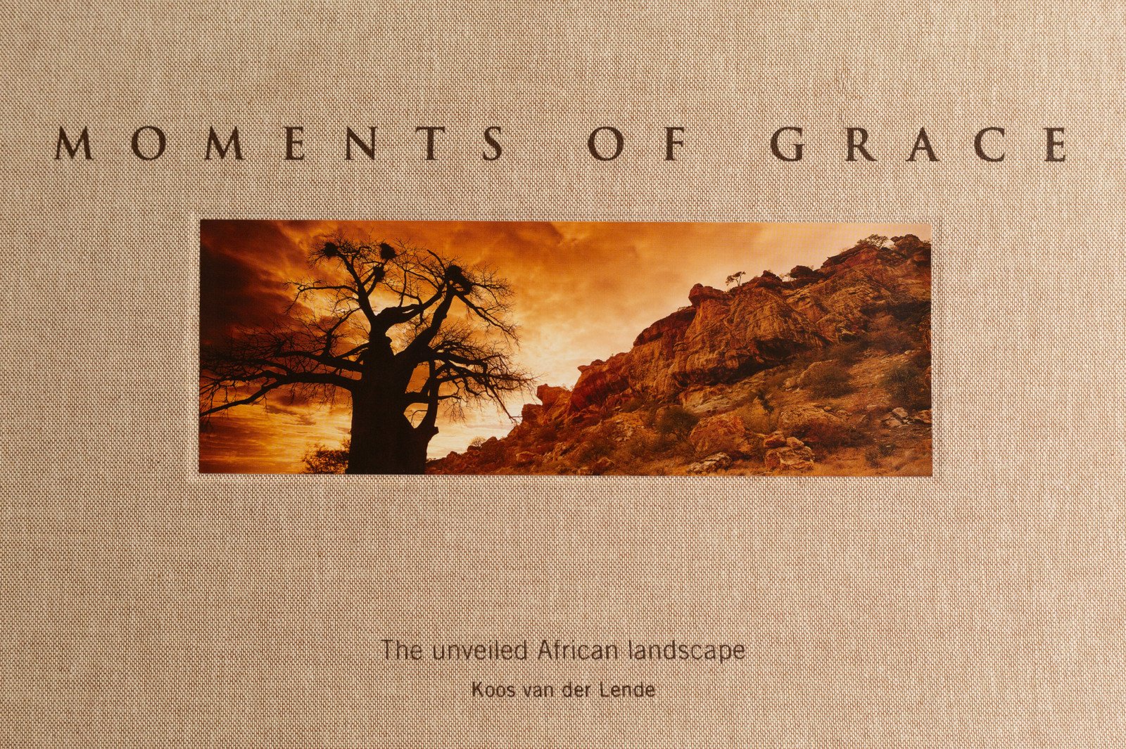 The linen cover of Moments of Grace with the African Sunrise baobab